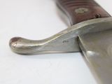 a close up of a knife on a white surface
