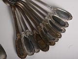 a lot of silver spoons and forks on the table