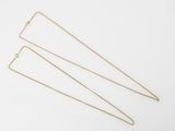 three gold chain necklaces on a white background