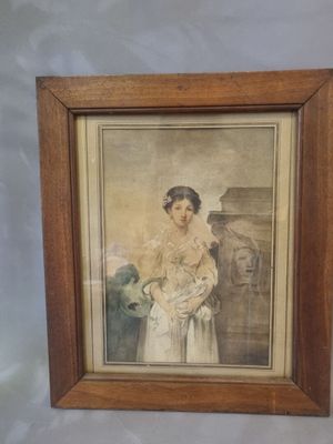 painting of a woman holding a baby in a wooden frame