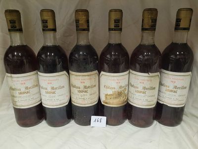 six bottles of wine are lined up in a row on a table