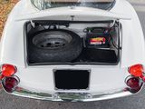a white car with its trunk open on the street