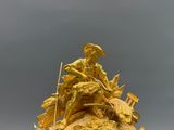 une statue représentant un homme à cheval, placée au sommet d'une autre statue