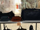 a display case with bags on it in a store