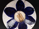 a blue and white plate with a flower on it