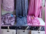 several dresses on display in a store with price tags on them