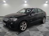 a picture of a black bmw suv parked in a garage