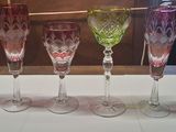 five wine glasses lined up on a white table