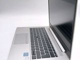 a silver laptop with a blue sticker on it