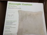 packaging of a massager cushion in a cardboard box on a table
