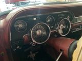 a dashboard of a car with a clock and other items in it