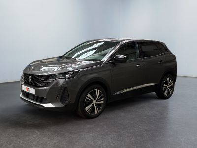 a grey car is parked in a room with a white wall