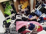 many pairs of socks and ties in boxes on a table