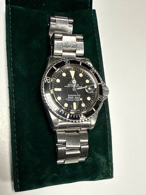 a watch that is sitting on a green velvet case