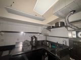 an image of a kitchen with a stove, sink, and microwave