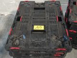 two black boxes with red handles sitting on the ground