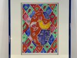 painting of a fish in a blue frame on a white wall