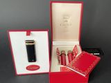 a red box that has a pen and a lighter in it
