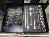a drawer full of tools that are sitting on the floor