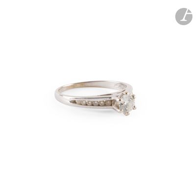 a close up of a diamond ring on a white background