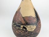 a vase that has a picture of a horse on it