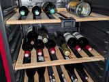 many bottles of wine in a wine cooler in the kitchen