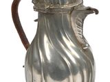 a silver coffee pot with a wooden handle on a white background