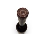 a black and brown waxed stamp on a white surface