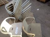 a lot of chairs that are stacked on top of each other