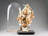 a vase with a bunch of flowers in it under a glass clochet