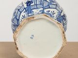 a blue and white vase sitting on top of a table