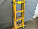 a yellow ladder leaning against a blue garage door