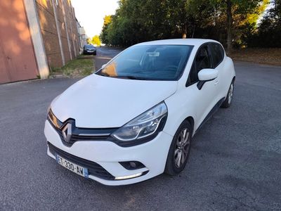 a white car parked on the side of the road in front of a building