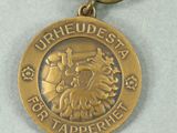 a medal with a ribbon around it on a table