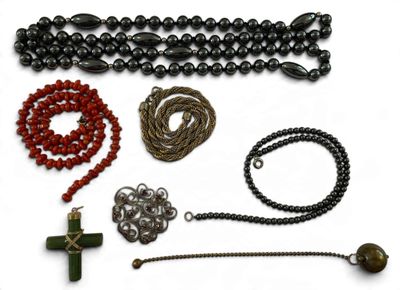 several different types of beads and chains on a white surface