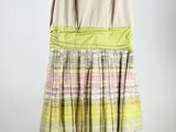 an image of a dress hanging on a hanger on a wall