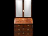 an antique wooden desk with a mirror on top of it