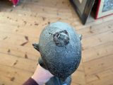 a person holding a rotten looking fruit in their hand