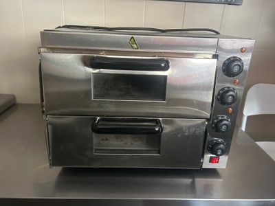 a silver oven sitting on a counter in a kitchen