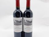 deux bouteilles de vin rouge posées l'une à côté de l'autre sur une surface blanche