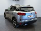the rear end of a silver citrole parked in a showroom