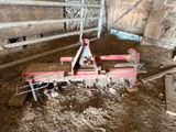a tractor that is sitting inside of a barn