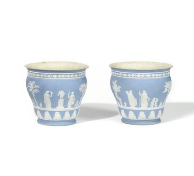two blue and white vases with figures on them