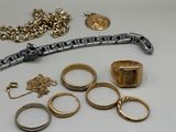 a lot of gold rings and other jewelry on the table