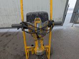 a machine that is sitting on the ground in front of a building