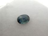 a blue sapphire stone sitting on top of a white surface