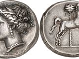 a silver coin with a horse and a woman on it