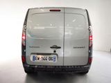 a silver van that is parked in a white room