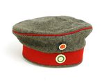 un chapeau orné d'un ruban rouge sur un fond blanc