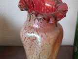 two vases sitting on a table next to each other